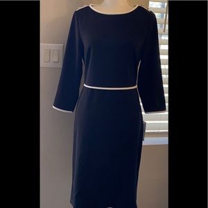 Black dress with white waistline, long sleeve.